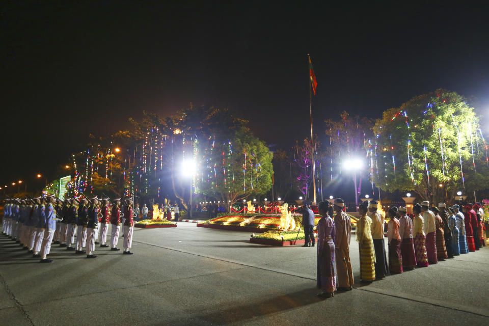 Members of an honor guard and representatives of national ethnic races salute at their national flag during a ceremony marking Myanmar's 76th anniversary of Independence Day in Naypyitaw, Myanmar, Thursday, Jan. 4, 2024. (AP Photo/Aung Shine Oo)