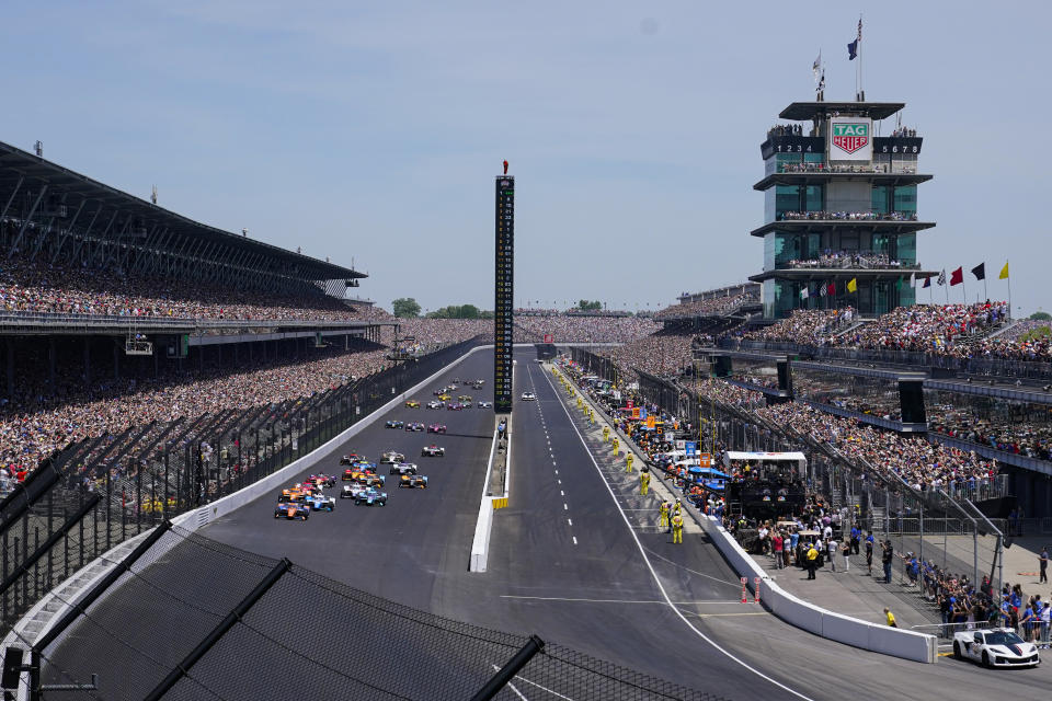 FILE ** Scott Dixon, (9) of New Zealand, leads the field on the start of the the Indianapolis 500 auto race at Indianapolis Motor Speedway in Indianapolis, Sunday, May 29, 2022. The Speedway returned to full capacity for the first time since 2020, when the pandemic put an unforeseeable end to large group gatherings. More than 325,000 people attended the 2022 race. (AP Photo/Michael Conroy, File)