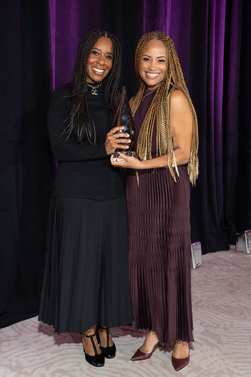 Tara Duncan (l.), president of Onyx Collective, receives The WICT Network Southern California’s LEA Award from Ayo Davis, president of Disney Branded Television.