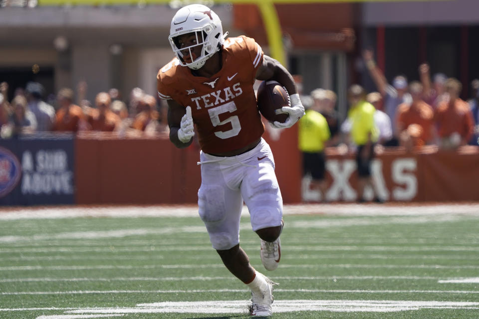 FILE - Texas running back Bijan Robinson (5) runs for a touchdown against Texas Tech during the second half of an NCAA college football game in Austin, Texas, in this Saturday, Sept. 25, 2021, file photo. Robinson was selected to The Associated Press Midseason All-America team, announced Tuesday, Oct. 19, 2021. (AP Photo/Chuck Burton, File)