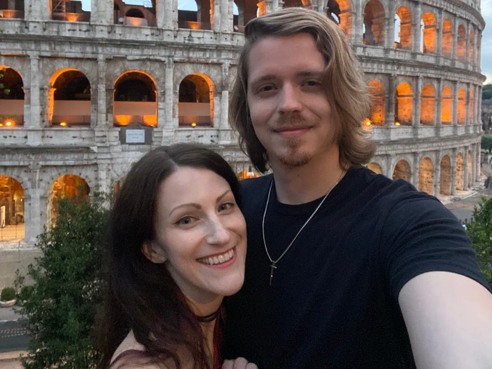 Jennifer Klesman and her boyfriend, Derek Moore, in a selfie taken outside a Roman coliseum.