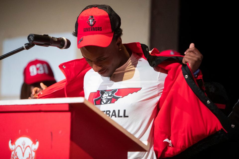 Germantown’s B.J. Blake removes his jacket to reveal his Austin Peay State University shirt during the signing ceremony on National Signing Day at Germantown High School in Germantown, Tenn., on Wednesday, December 20, 2023.