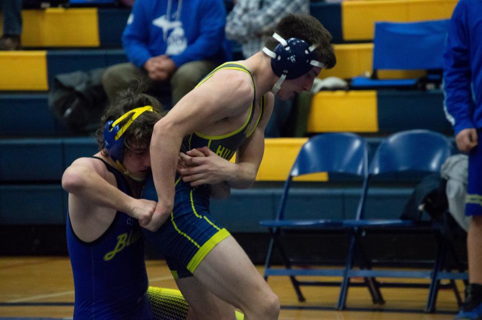 A Hillsdale wrestler attempts to escape an Ida wrestler.