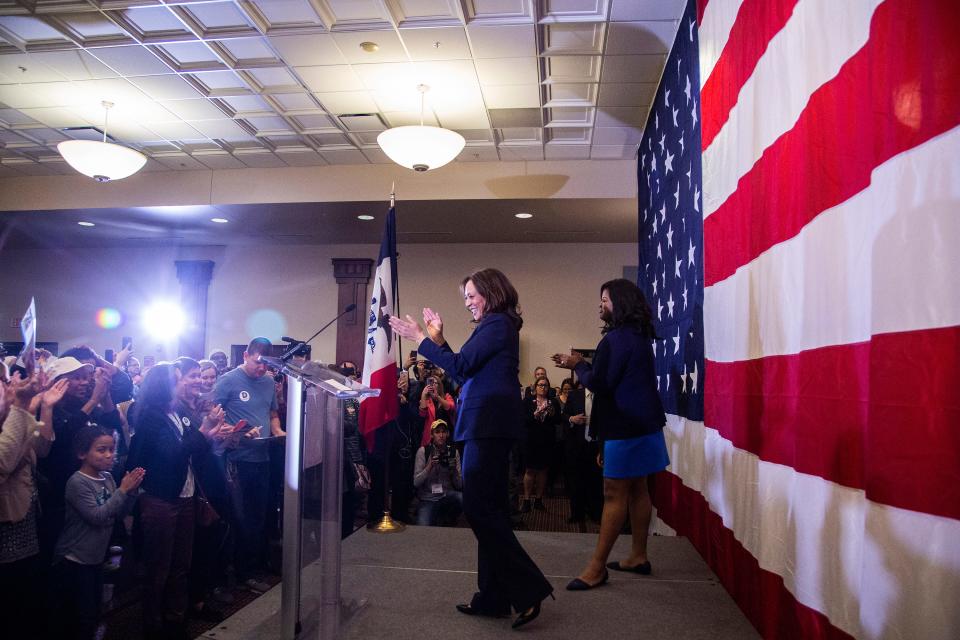 Kamala Harris, a Democratic senator from California, and Iowa secretary of state candidate Deidre DeJear cheer from stage at the end of a rally with Polk County Democrats on Monday, Oct. 22, 2018, in Des Moines.