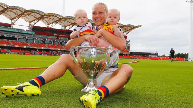 Phillips and her twins Brooklyn and Blake after winning the inaugural AFLW premiership. Image: Getty