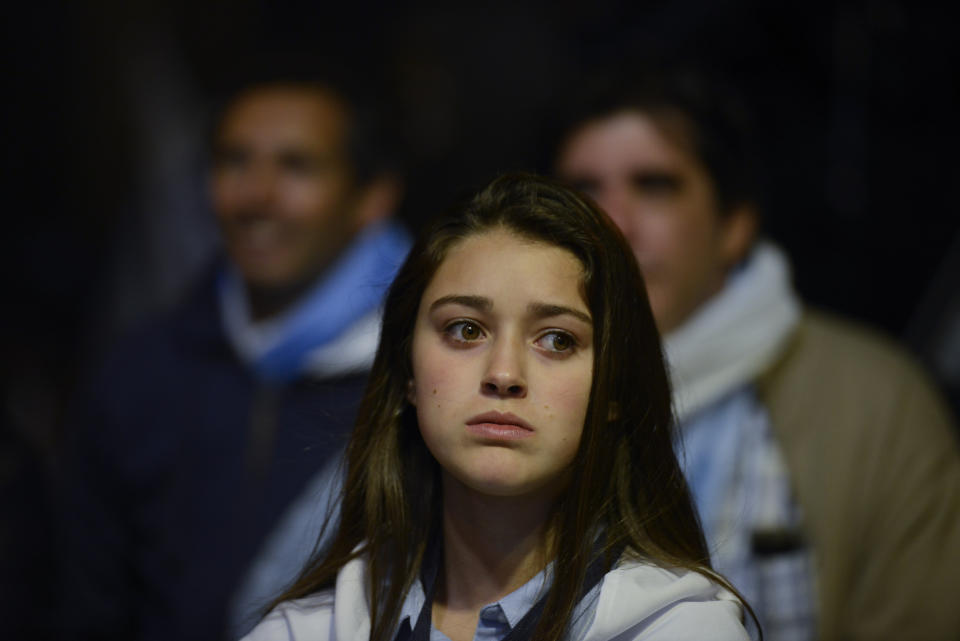 Supporters of opposition presidential candidate Luis Lacalle Pou wait for the election results at the party's headquarters in Montevideo, Uruguay, Sunday, Nov. 24, 2019. Uruguayans are choosing between Presidential candidate for the ruling party Broad Front Daniel Martinez and Lacalle. (AP Photo/Santiago Mazzarovich)