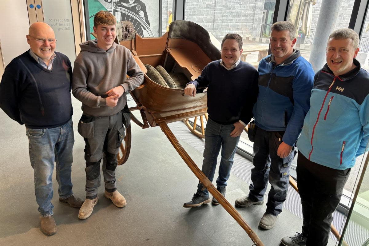 The McKeagney family pictured with the traditional tub trap, crafted by their ancestor in 1914 <i>(Image: Fermanagh County Museum)</i>