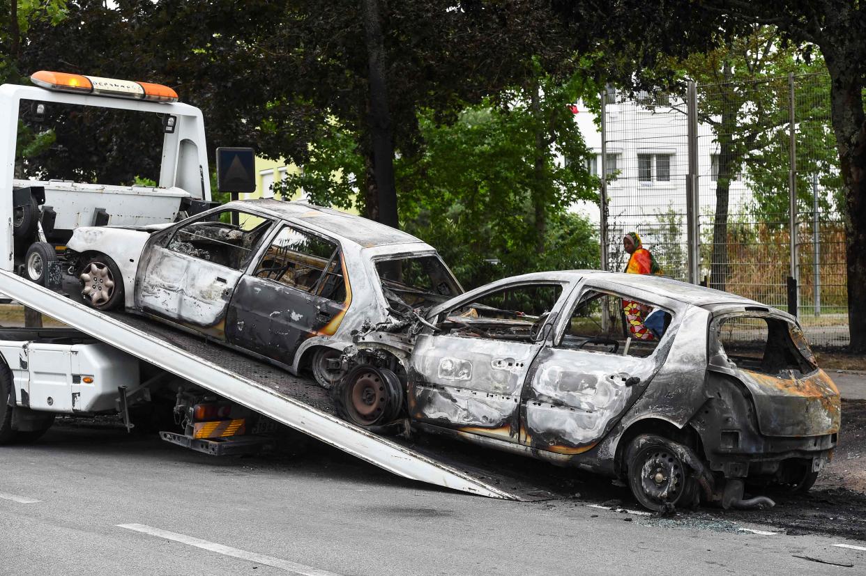 Wreckages of burnt cars being removed in Nantes, western France (AFP via Getty Images)