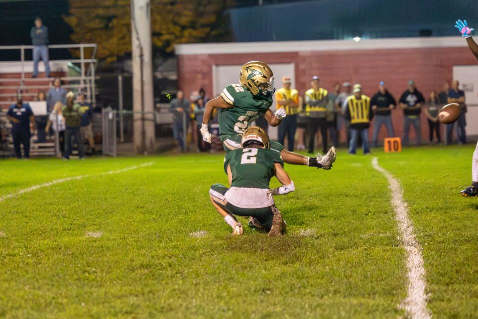 Ian Foster holds as Drew Harris kicks a game-winning field goal against Detroit Loyola Friday night. SMCC won the Division 7 state playoff game 10-7 in overtime.