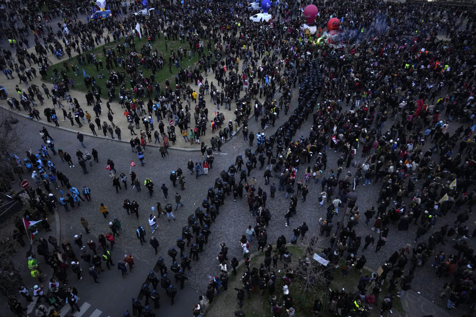 A line of riot police officers divides protestors at the end of the demonstration against plans to push back France's retirement age, at the Invalides monument, Tuesday, Jan. 31, 2023 in Paris. Labor unions aimed to mobilize more than 1 million demonstrators in what one veteran left-wing leader described as a "citizens' insurrection." The nationwide strikes and protests were a crucial test both for President Emmanuel Macron's government and its opponents. (AP Photo/Thibault Camus)