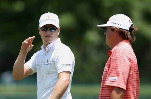 Zach Johnson (L) walks up the second fairway with Jason Dufner during the final round of the Crowne Plaza Invitational at Colonial at the Colonial Country Club in Fort Worth, Texas, on May 27. Johnson fired a two-over 72 that included a two-shot penalty at the final hole to win the event, denying Dufner a third US PGA victory this season