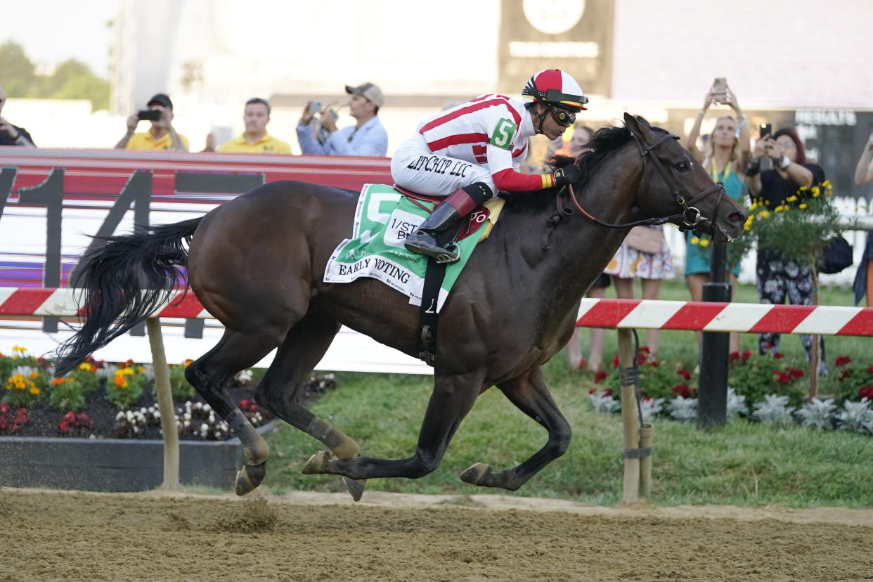 Jose Ortiz atop Early Voting wins the 147th running of the Preakness Stakes horse race at Pimlico Race Course, Saturday, May 21, 2022, in Baltimore. (AP Photo/Julio Cortez)