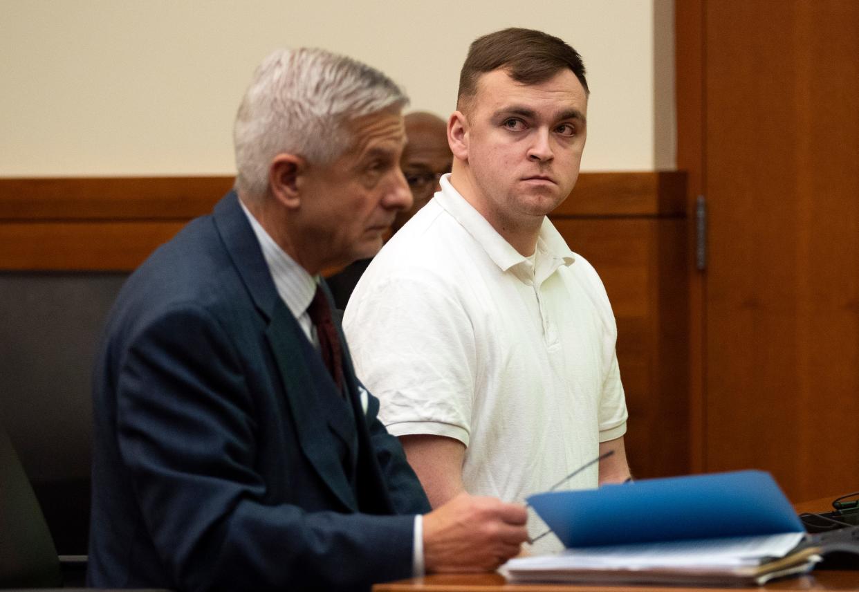 Former Ohio Army National Guardsman Thomas DeVelin, 25, of Columbus, (right) sits with his defense attorney, Bob Krapenc, Tuesday in Franklin County Common Pleas Court, where DeVelin entered his guilty plea to two counts of making terroristic threats and one count of the attempted illegal manufacturing or possession of explosives. He was sentenced to six years in prison, to be served concurrently with a 5 year, 11-month sentence in federal court for illegal sales of ghost guns and devices to make semiautomatic weapons fire as automatics.