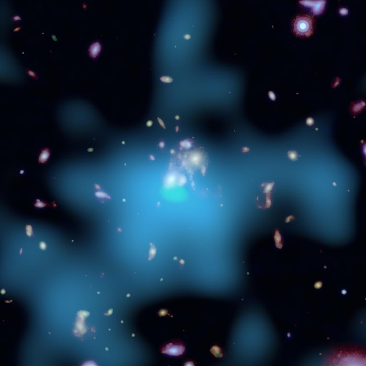 This composite image of X-rays from Chandra (light blue) and optical data from Hubble (blue, green, red) shows a galaxy cluster with a black hole that has stopped being active (NASA) 