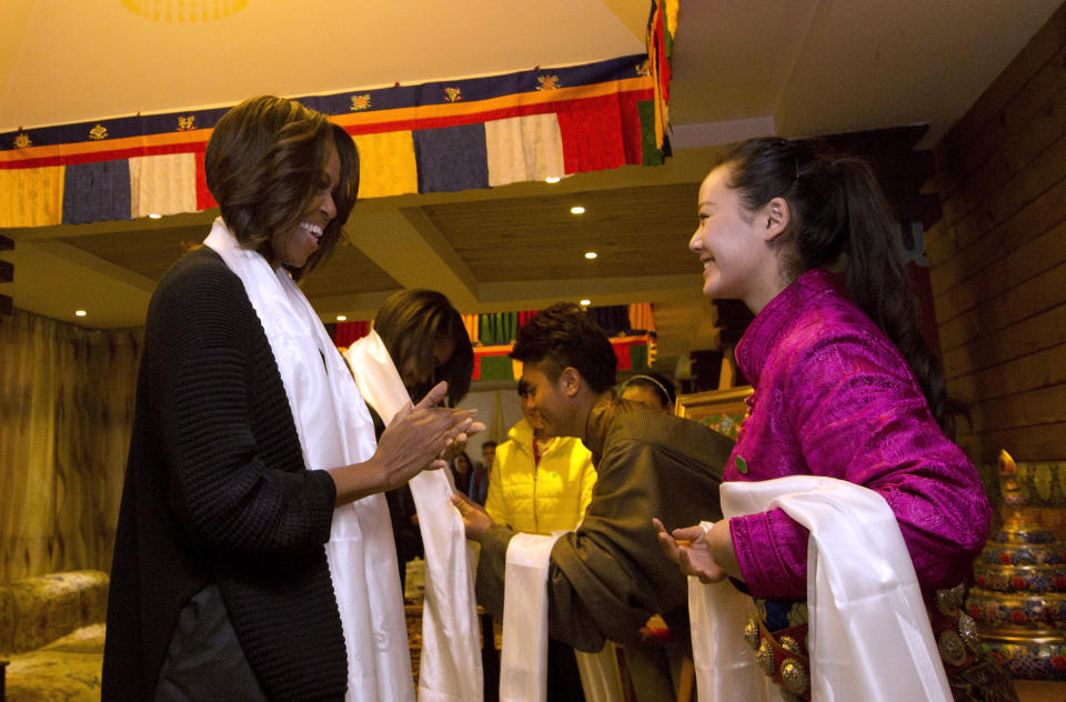 U.S. first lady Michelle Obama, left, is greeted by Tibetan students as they arrive to a Tibetan restaurant for lunch in Chengdu in southwest China's Sichuan province Wednesday, March 26, 2014. (AP Photo/Andy Wong, Pool)