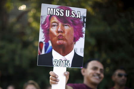 People protest outside the Luxe Hotel, where Republican presidential candidate Donald Trump was expected to speak in Brentwood, Los Angeles, California, United States July 10, 2015. REUTERS/Lucy Nicholson