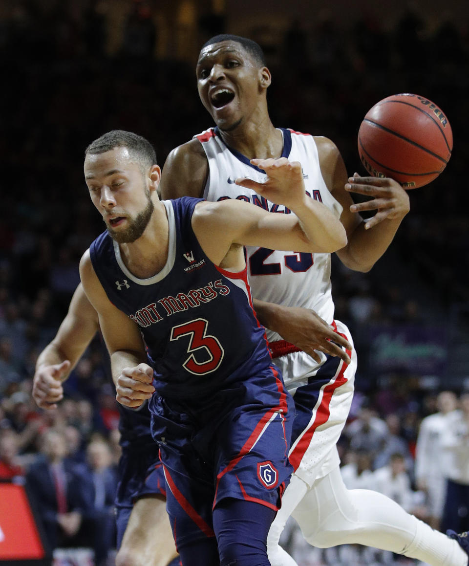 St. Mary's Jordan Ford (3) and Gonzaga's Zach Norvell Jr. collide during the first half of an NCAA college basketball game for the West Coast Conference men's tournament title, Tuesday, March 12, 2019, in Las Vegas. (AP Photo/John Locher)