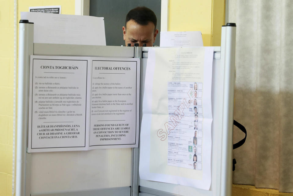 Taoiseach Leo Varadkar arrives to cast his vote at Scoil Thomais, Castleknock as people across the Republic of Ireland go to the polls to vote in the European and local elections along with the referendum on Ireland's divorce laws, in Dublin, Friday May 24, 2019. (Brian Lawless/PA via AP)