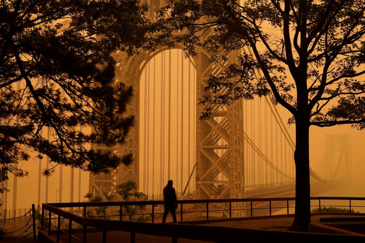 Thick smoke from hundreds of wildfires in Canada blanketed New York City on Wednesday, leaving it with another-wordly orange glow (AP Photo/Seth Wenig, File) (Copyright 2023 The Associated Press. All rights reserved.)