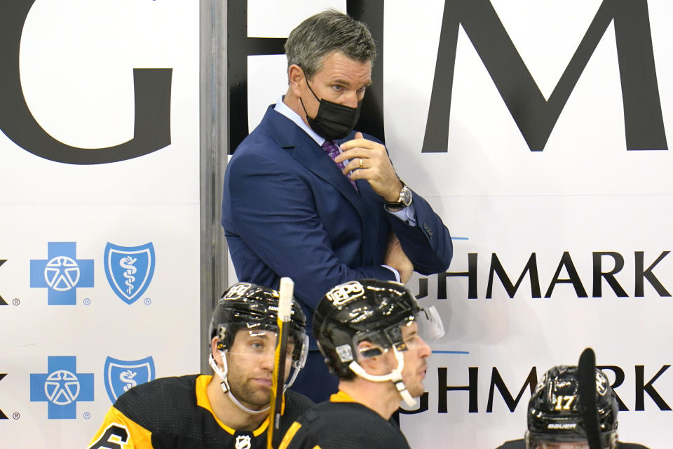 Pittsburgh Penguins head coach Mike Sullivan stands behind his bench during the third period of an NHL hockey game against the Washington Capitals in Pittsburgh, Sunday, Jan. 17, 2021. (AP Photo/Gene J. Puskar)