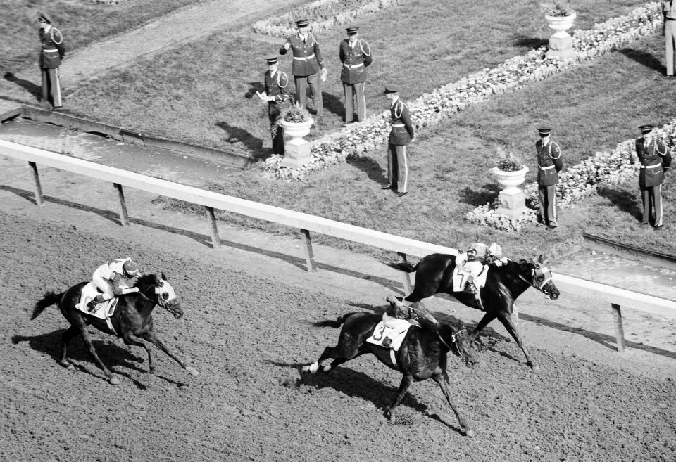 FILE - Tim Tam goes from even-Stephen with Lincoln Road (7) to finish half a length ahead at the wire in at the Kentucky Derby, May 3, 1958 in Louisville, Ky. America’s longest continuously held sporting event turns 150 years old Saturday. The Kentucky Derby has survived two world wars, the Depression and pandemics, including COVID-19 in 2020, when it ran in virtual silence without the usual crowd of 150,000.(AP Photo/File)