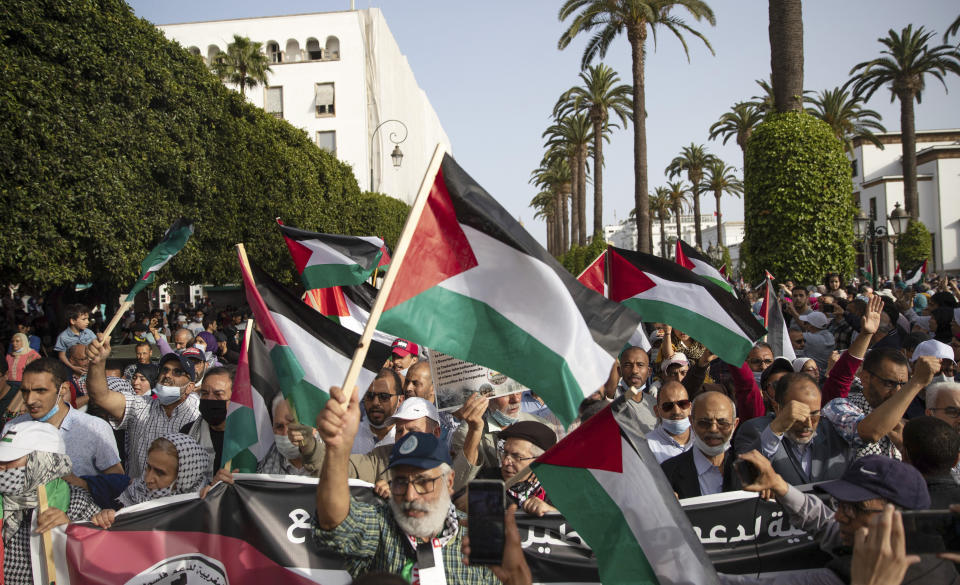 Protesters shout slogans and wave Palestinian flags during a protest in Rabat, Morocco, Sunday, May 16, 2021. (AP Photo/Mosa'ab Elshamy)