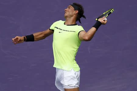 Apr 2, 2017; Key Biscayne, FL, USA; Rafael Nadal of Spain serves against Roger Federer of Switzerland (not pictured) in the men's singles championship of the 2017 Miami Open at Crandon Park Tennis Center. Mandatory Credit: Geoff Burke-USA TODAY Sports