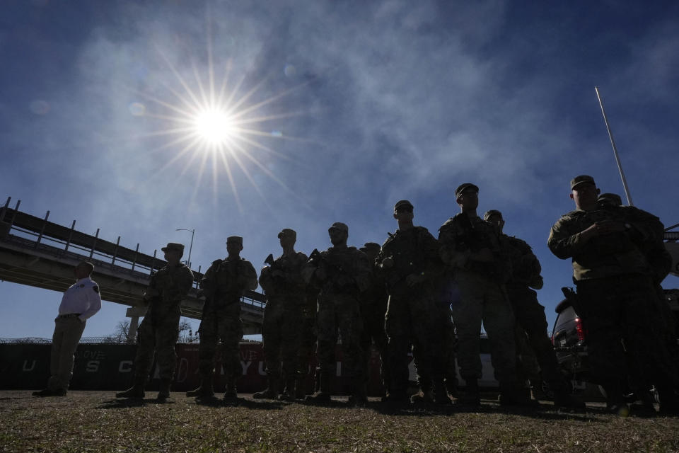 FILE - Members of the National Guard stand as Texas Gov. Greg Abbott and fellow governors hold a news conference along the Rio Grande to discuss Operation Lone Star and border concerns, Feb. 4, 2024, in Eagle Pass, Texas. Louisiana’s Republican-controlled Senate has advanced a bill Monday, April 8, that would empower state and local law enforcement to arrest and jail people in the state who enter the U.S. illegally, similar to embattled legislation in Texas. (AP Photo/Eric Gay, File)