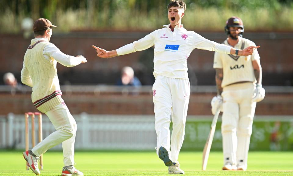 <span>Archie Vaughan celebrates after picking up one of his 11 wickets in a match for Somerset against Surrey at Taunton this season.</span><span>Photograph: Harry Trump/Getty Images</span>