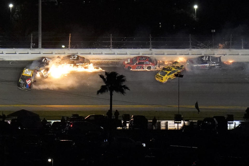 Racers crash during the last lap in the NASCAR Daytona 500 auto race at Daytona International Speedway, Monday, Feb. 15, 2021, in Daytona Beach, Fla. Joey Logano (22) was leading before the wreck; Brad Keselowski (2) was in second. (AP Photo/Chris O'Meara)