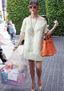 Celebrities in pastel fashion: Kourtney Kardashian teamed her pastel yellow frock with a bright orange Birkin bag.<br><br>© Rex