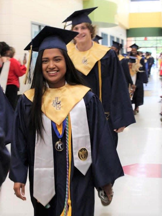 FILE - Jeyly Ambrosio smiles for a photograph in her graduation robes. Ambrosio was the Jefferson County High School class of 2023 valedictorian.