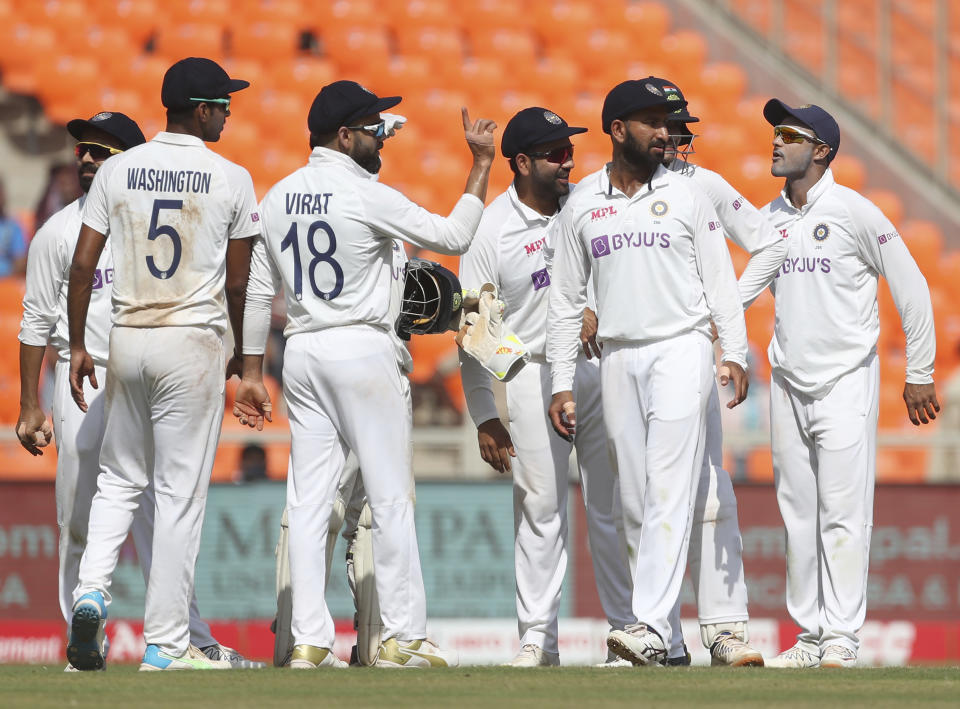 India's captain Virat Kohli, center, gestures to the umpire after watching the replay of England's Ben Foakes' dismissal during the third day of fourth cricket test match between India and England at Narendra Modi Stadium in Ahmedabad, India, Saturday, March 6, 2021. (AP Photo/Aijaz Rahi)