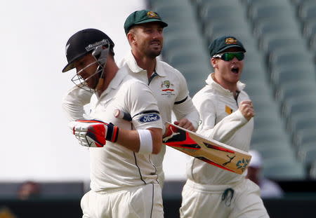 Australia's captain Steve Smith (R) and team mate Shaun Marsh celebrate after New Zealand's captain Brendon McCullum (L) was dismissed for four runs during the first day of the third cricket test match at the Adelaide Oval, in South Australia, November 27, 2015. REUTERS/David Gray