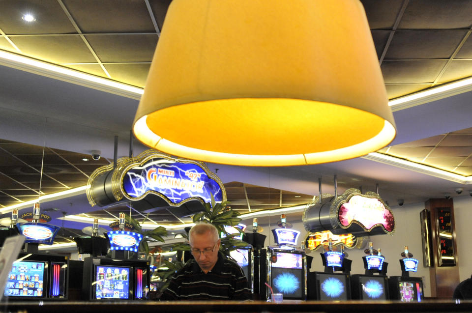 A man plays slot machine roulette in a gambling hall in Budapest, Hungary, Wednesday, Oct. 3, 2012. Hungary’s ban on slot machines has taken the country’s gambling industry by surprise. On Tuesday, just over 24 hours after the announcement, lawmakers in the Hungarian Parliament voted in favor of a new bill which bans the country's slot machines. (AP Photo/Bela Szandelszky)