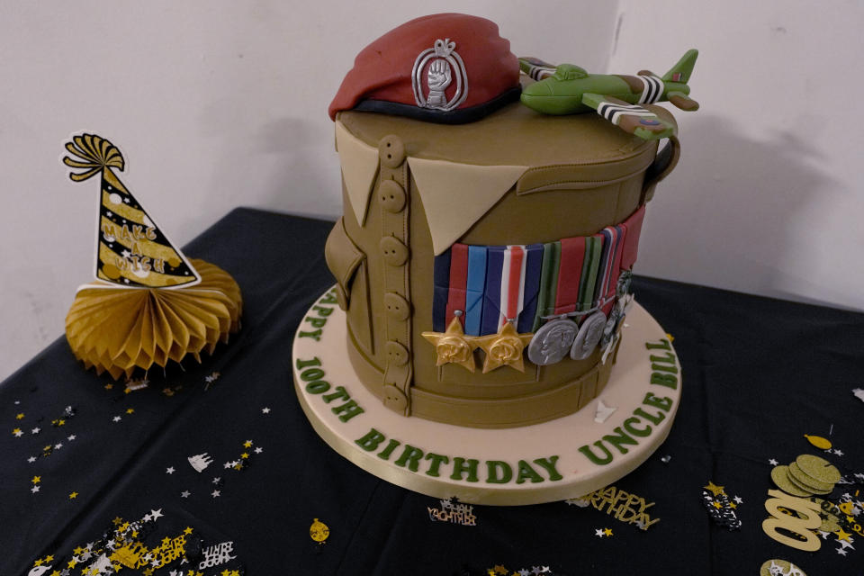 A birthday cake specially designed and made for D-Day veteran Bill Gladden surprises birthday party in Haverhill, England, Friday, Jan. 12, 2024. Gladden spoke to the AP on the eve of his 100th birthday, and is a veteran of the 6th Airborne Armoured Reconnaissance Regiment, part of the British 6th Airborne Division, he landed by glider on the afternoon of D-day, 6th June 1944 in Normandy. Gladden was born on jan. 13, 1924. (AP Photo/Alastair Grant)