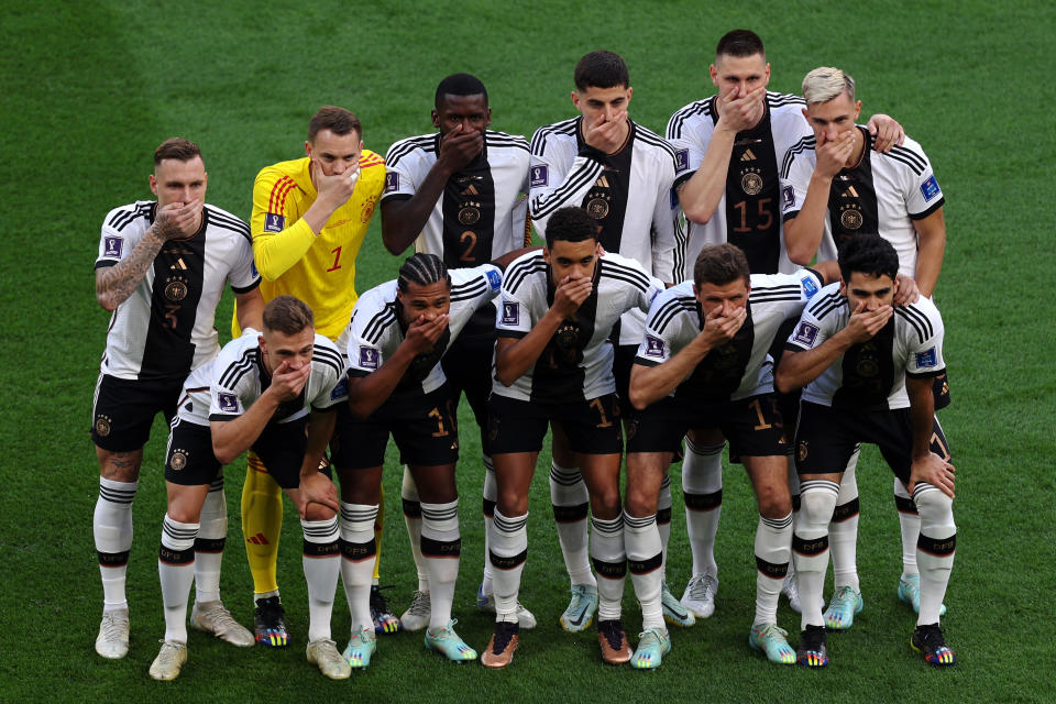 DOHA, QATAR - NOVEMBER 23: Germany players pose with their hands covering their mouths as they line up for the team photos prior to the FIFA World Cup Qatar 2022 Group E match between Germany and Japan at Khalifa International Stadium on November 23, 2022 in Doha, Qatar.  (Photo by Dean Mouhtaropoulos/Getty Images)