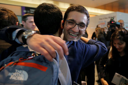 Behnam Partopour, a Worcester Polytechnic Institute (WPI) student from Iran, is greeted by friends at Logan Airport after he cleared U.S. customs and immigration on an F1 student visa in Boston, Massachusetts, U.S. February 3, 2017. Partopour was originally turned away from a flight to the U.S. following U.S. President Donald Trump's executive order travel ban. REUTERS/Brian Snyder