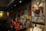 In this Oct. 9, 2020 photo, former lawmaker and pro-democracy activist Leung Kwok-hung, known as "Long Hair," shows his palm with five fingers open, signifying the five demands of protesters, at Club 71 in Hong Kong. The bar known as a gathering place for pro-democracy activists and intellectuals is closing. (AP Photo/Kin Cheung))