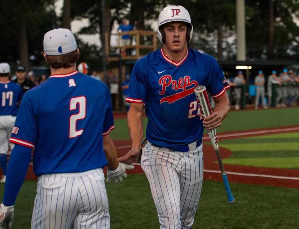 Jackson Prep Patriots' Konnor Griffin (22) high fives Gardner Young (2) after scoring a run during the game against the Presbyterian Christian Bobcats at Jackson Prep in Flowood, Miss., on Tuesday, May 14, 2024. Jackson Prep won 3-2.