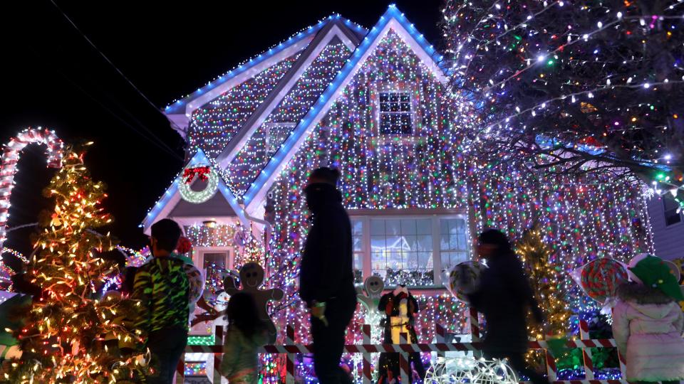 People from around northern New Jersey look at homes on the 200 block of Forest Ave. in Lyndhurst, which are decorated with Christmas lights. Sunday, December 13, 2020