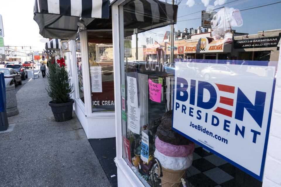 A sign for President-elect Joe Biden is displayed in a shop window, Friday, Nov. 13, 2020, in Rehoboth Beach, Del. This resort town known for Atlantic waves that are sometimes surfable, fresh-cut French fries and a 1-mile wooden boardwalk that dates back to the 1870s has long prided itself on being the “Nation's Summer Capital.” It may soon sport a beach White House. (AP Photo/Alex Brandon)