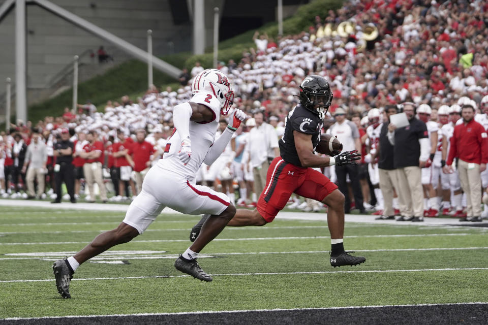 Cincinnati running back Ryan Montgomery, right, runs into the end zone for a touchdown during the first half of an NCAA college football game against Miami (Ohio), Saturday, Sept. 4, 2021, in Cincinnati. (AP Photo/Jeff Dean)