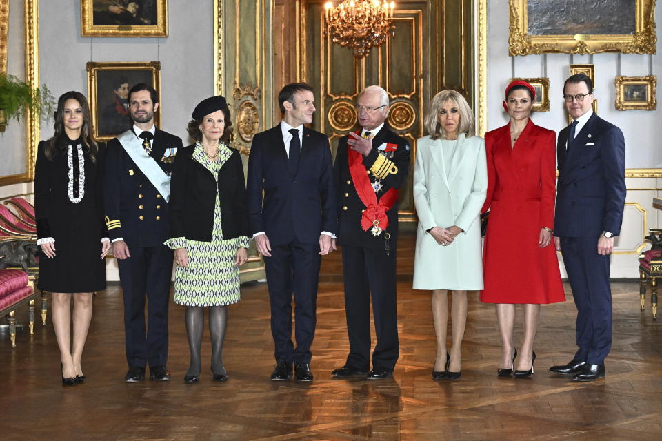 French President Emmanuel Macron, center left, and his wife Brigitte Macron, 3rd right, pose for a group photo with Sweden's King Carl XVI Gustaf, center right, Queen Silvia,, 3rd left, Crown Princess Victoria, 2nd right, Prince Daniel, right, Princess Sofia, left, and Prince Carl Philip, 2nd left, at the Royal Palace in Stockholm, Sweden, Tuesday Jan. 30, 2024. France’s President Emmanuel Macron started a two-day state visit in Stockholm during which he will meet Swedish prime minister, Ulf Kristersson, and the country’s monarch, King Carl XVI Gustaf. (Claudio Bresciani/TT via AP)