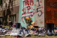 <p>Shoes were laid around the statue of Egerton Ryerson at Ryerson University as a memorial following the discovery of 215 bodies of students from residential schools in Kamloops, British Columbia. (Photo by Shawn Goldberg/SOPA Images/LightRocket via Getty Images)</p> 