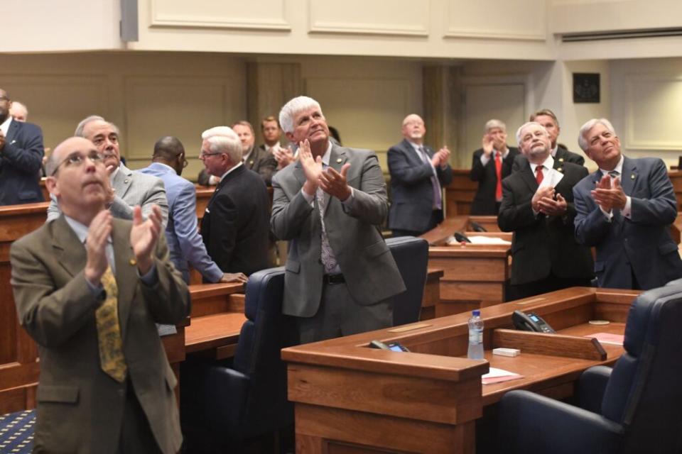 Men in suits applauding