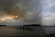 <p>A wildfire is visible from Leek’s Marina on the shore of Jackson Lake, in north Grand Teton National Park, Wyo., Aug. 24, 2016. (AP Photo/Brennan Linsley) </p>