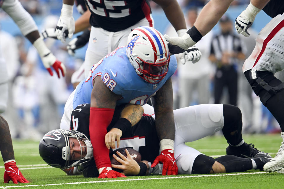 Atlanta Falcons quarterback Taylor Heinicke (4) is sacked by Tennessee Titans defensive tackle Jeffery Simmons (98) during the second half of an NFL football game, Sunday, Oct. 29, 2023, in Nashville, Tenn. (AP Photo/John Amis)