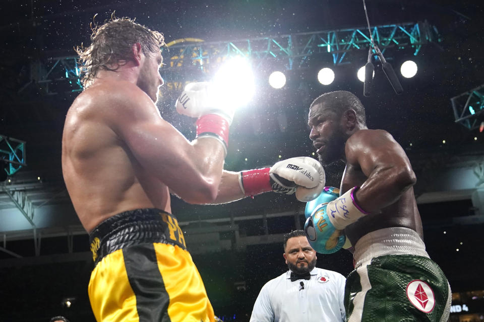 Logan Paul, left, and Floyd Mayweather fight during an exhibition boxing match at Hard Rock Stadium, Sunday, June 6, 2021, in Miami Gardens, Fla. (AP Photo/Lynne Sladky)