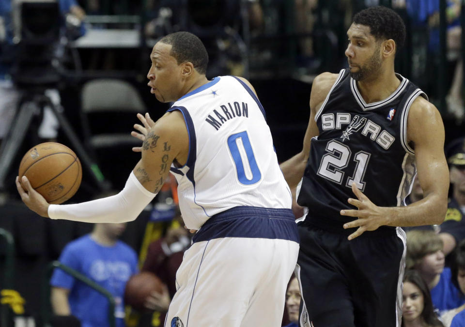 Dallas Mavericks forward Shawn Marion (0) steals the ball in front of San Antonio Spurs forward Tim Duncan (21) during the first half of Game 3 of in the first round of the NBA basketball playoffs in Dallas, Saturday, April 26, 2014. (AP Photo/LM Otero)